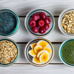 A vibrant flat lay composition of diverse healthy and functional snacks on a light wooden table. The display features artisanal protein bars crafted from dates and oats, colorful chia seed puddings in elegant glass jars, and small bowls brimming with fresh berries, nuts, and spirulina-infused yogurt. Natural light illuminates the scene, highlighting the textures and fresh ingredients. Professional food photography, sharp focus, high resolution, appealing colors, safe for work, appropriate content, fully clothed, modest, family-friendly.
